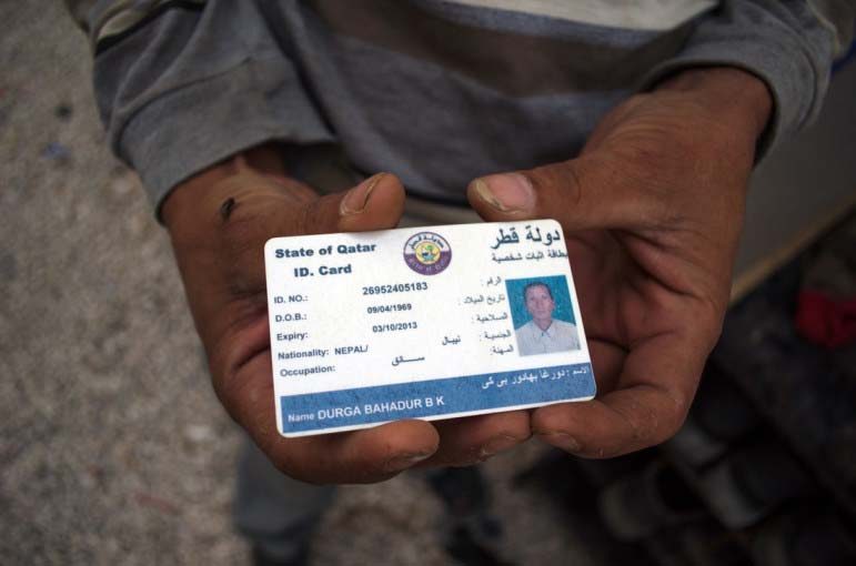 Durga Bahadur B.K. holds his Qatar ID, which expired in October, leaving him with no means to access medical care.