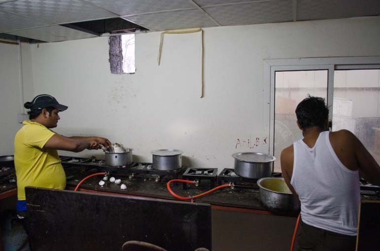 Construction workers make dinner at a labor camp in As Sayliyah, Qatar.