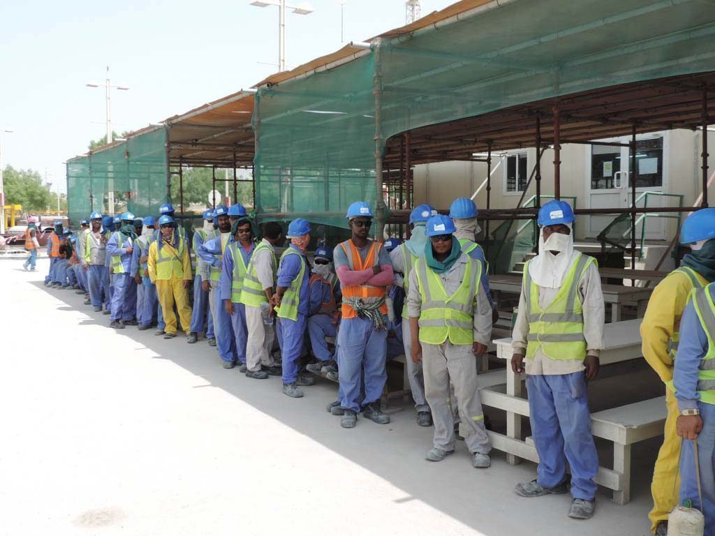 Construction workers queue at Khalifa Stadium