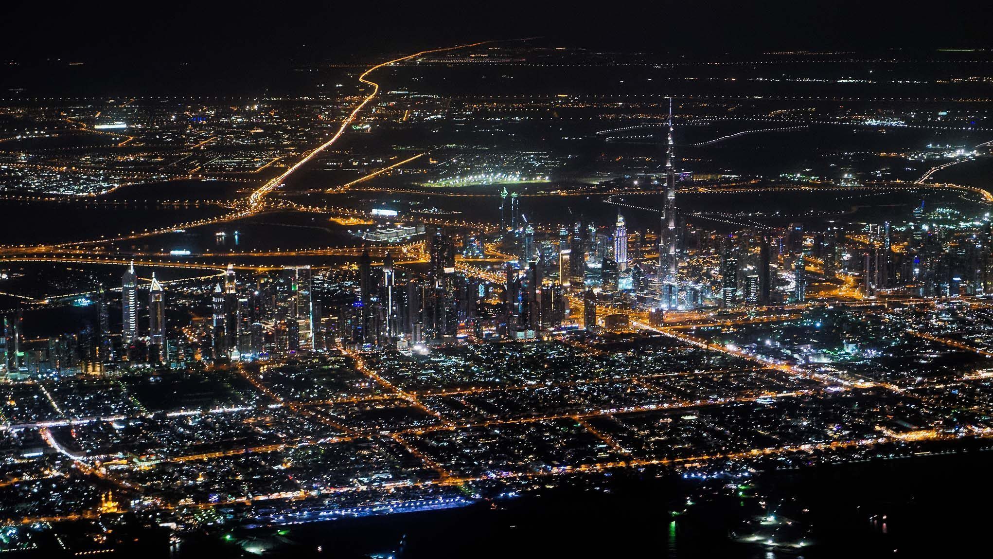 Dubai at night, showing the Burj Khalifa towering over other skyscrapers