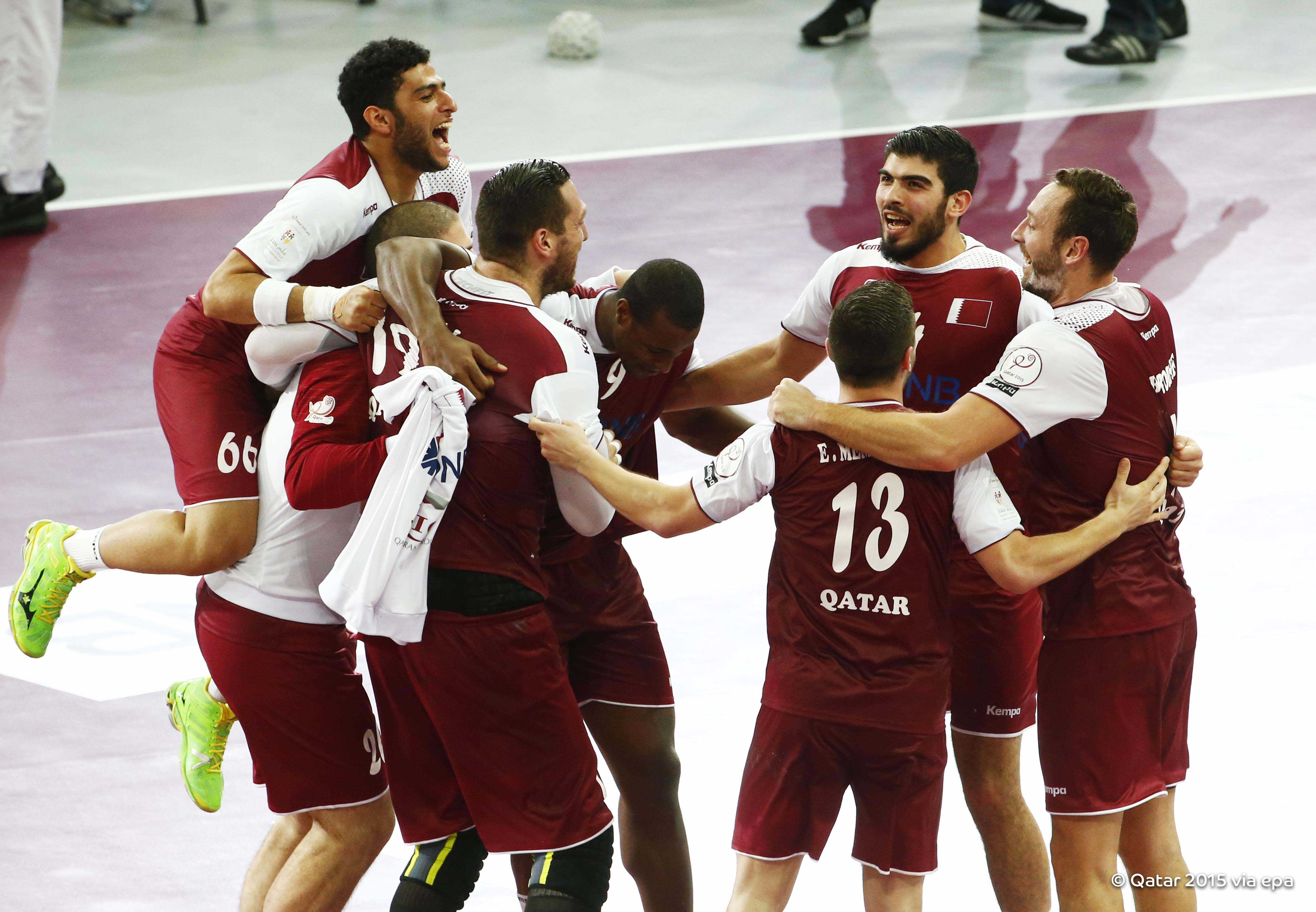 Qatari players celebrate after winning the Qatar 2015 24th Men's Handball World Championship semi final between Poland and Qatar in January 2015. 