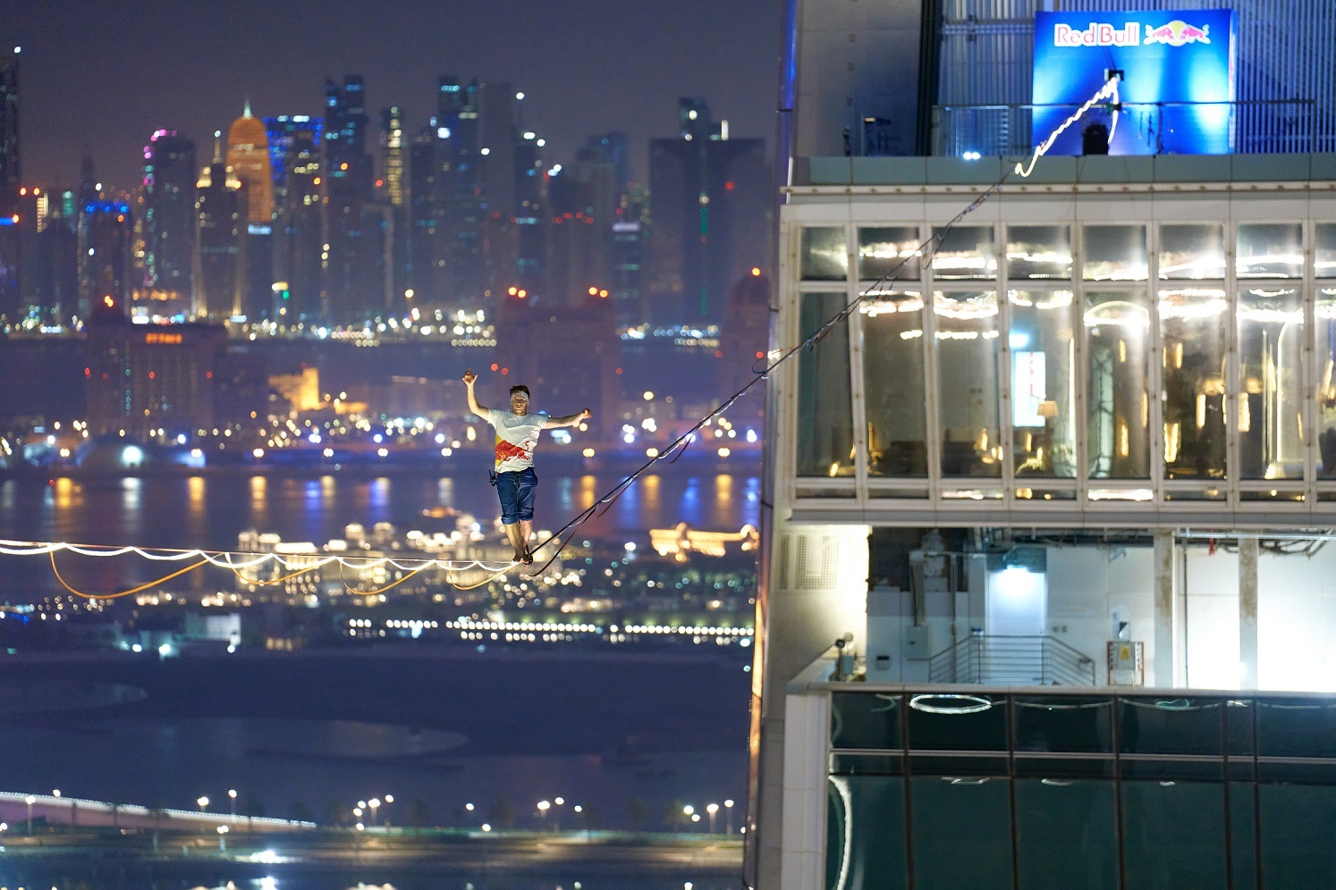 Daredevil athlete sets record for longest LED slackline walk on iconic Qatar tower